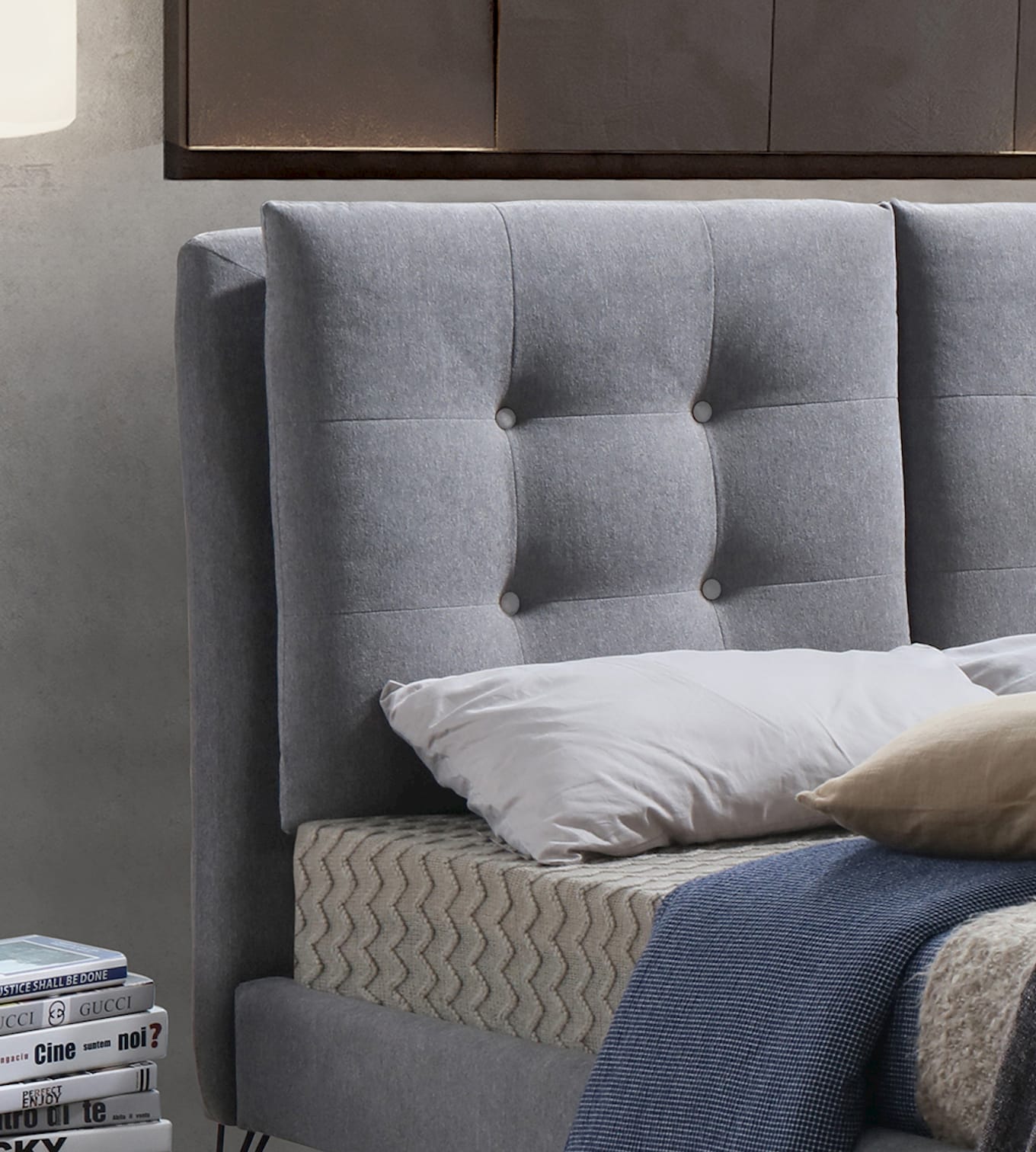 Close up of grey bed in bedroom