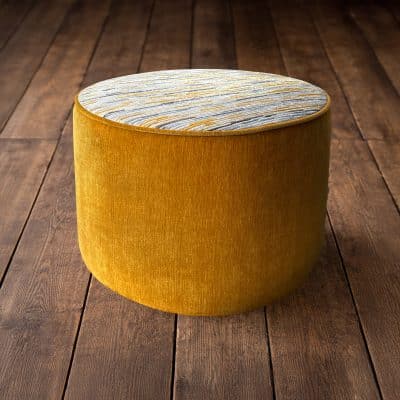 Yellow and striped stool on floorboards