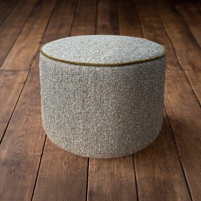 Green and grey boucle stool on floorboards